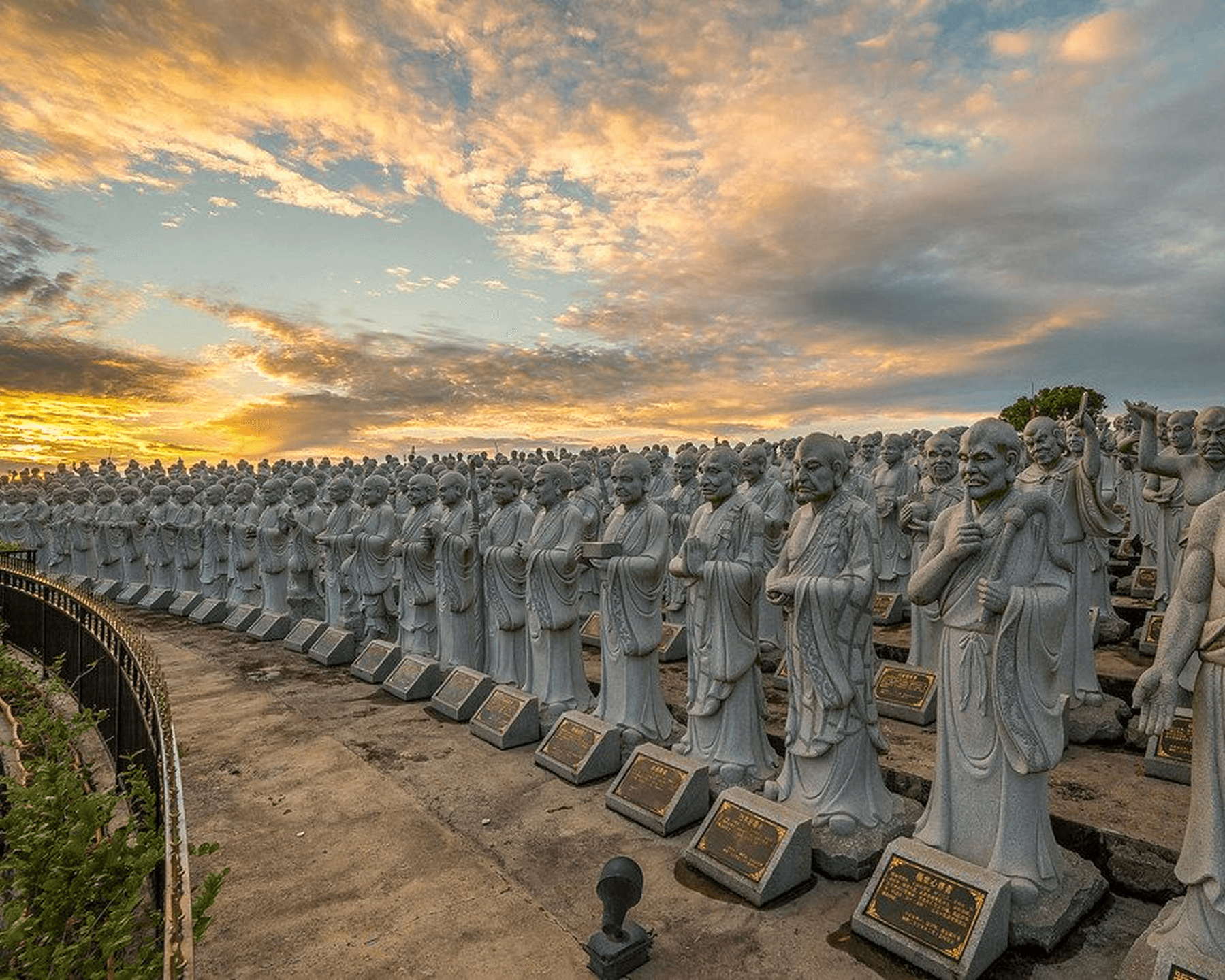 Rows of temple statues during sunset